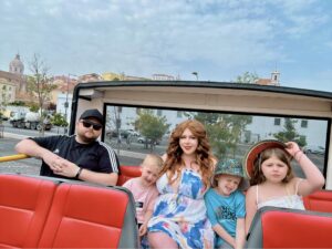Let’s roam and go Family of 5 sat on hop on hop off city tour bus